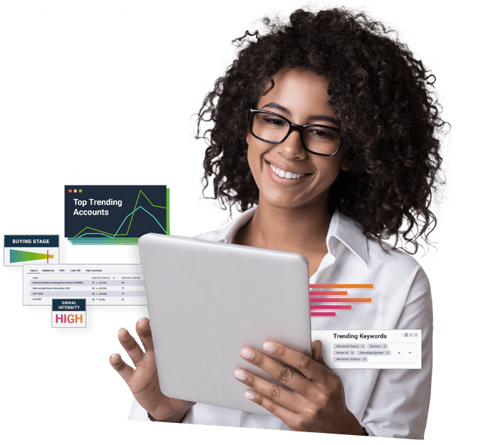 A woman smiling holding a tablet and learning the Intentsify platform